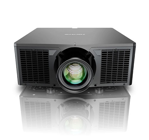 Large black projector with green reflected in its lens.