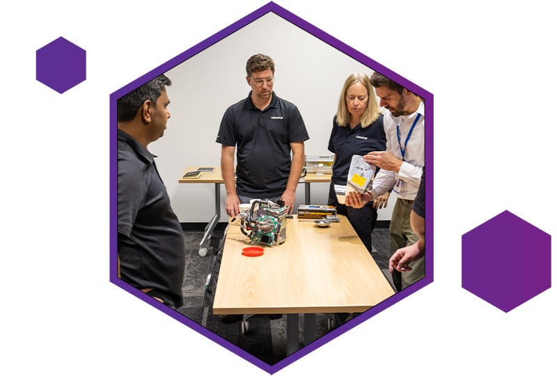 An image of a group of people smiling and waving