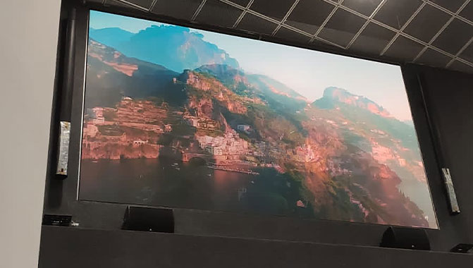 Looking up at an LED video wall featuring a landscape image.  