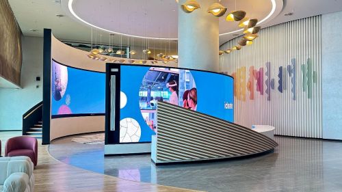 A curved LED wall display in a modern corporate lobby