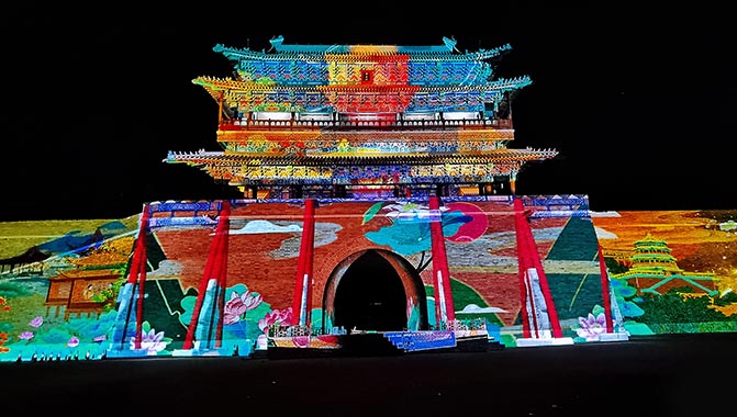Stunning projection mapping installation using Christie HS Series laser projectors on the ancient city tower at Huayi Brothers Movie Town