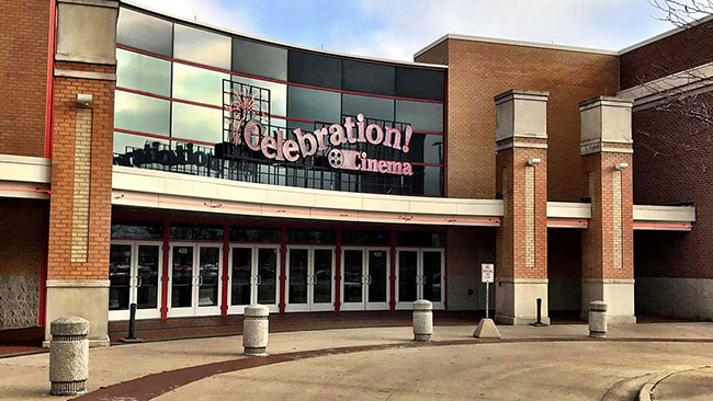 Exterior shot of a brown building with signage that reads “Celebration! Cinema” 