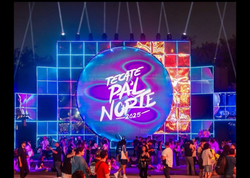 A large spherical sculpture is projection mapped in blues and purples.