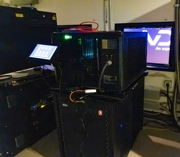 A large cinema projector in a projection booth.